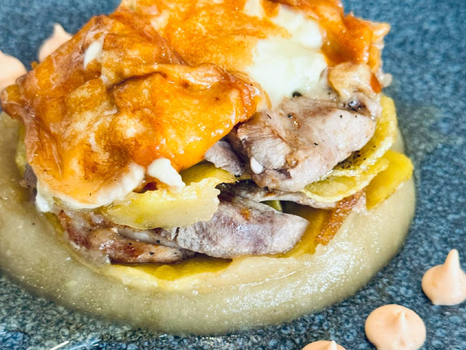 Timbal de patata confitada con compota de manzana, láminas de solomillo de cerdo y crujiente de queso de cabra, de La Josefita